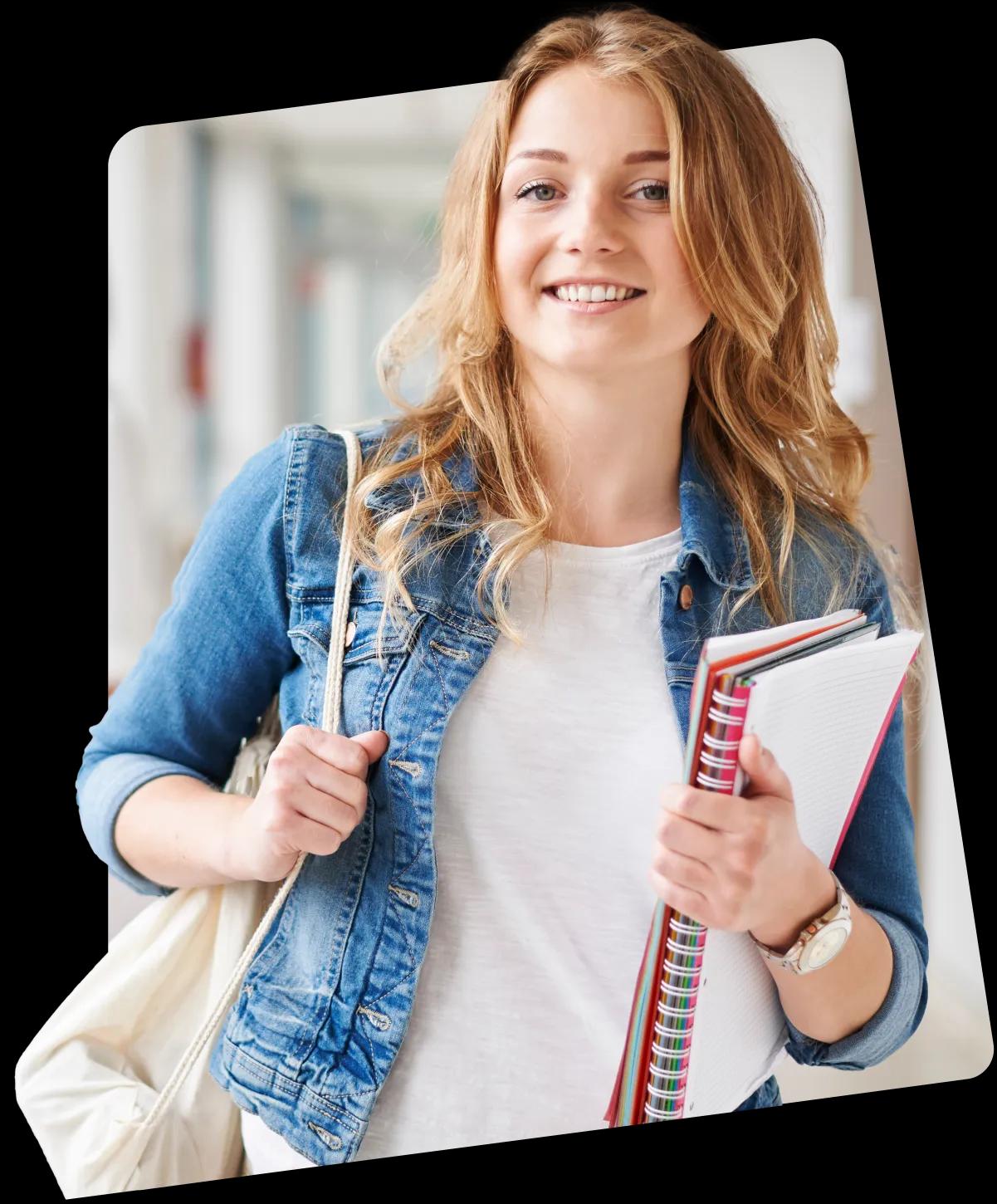 A smiling lady on blue jacket with a white bag